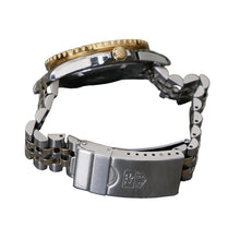 Load image into Gallery viewer, Close-up of a watch with a gold crown and silver metal band on a gray background