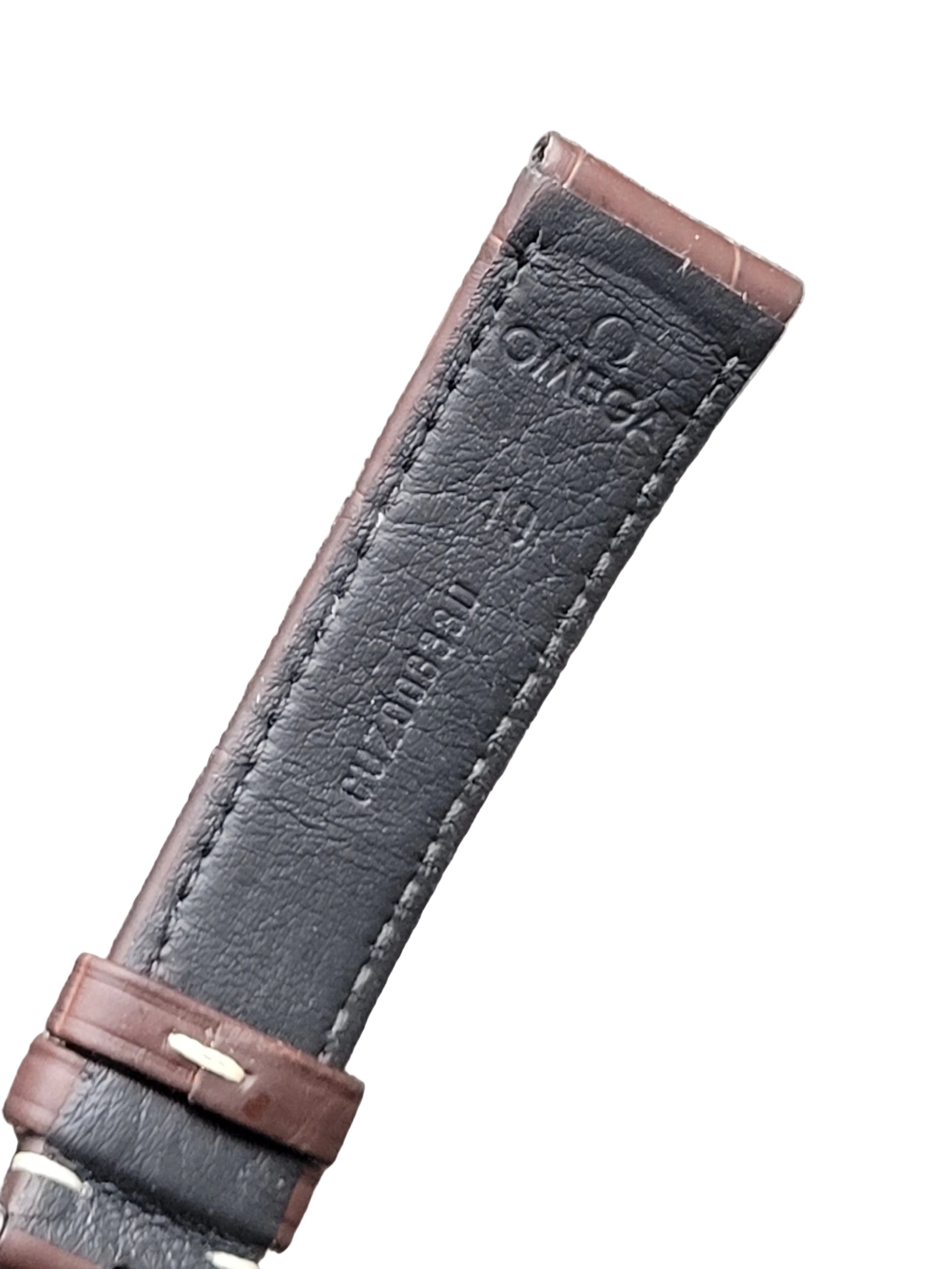 Omega watch strap with brown leather and dark gray interior on a gray background