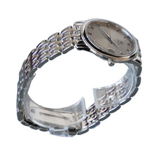 Load image into Gallery viewer, Silver wristwatch on a clear stand against a gray background
