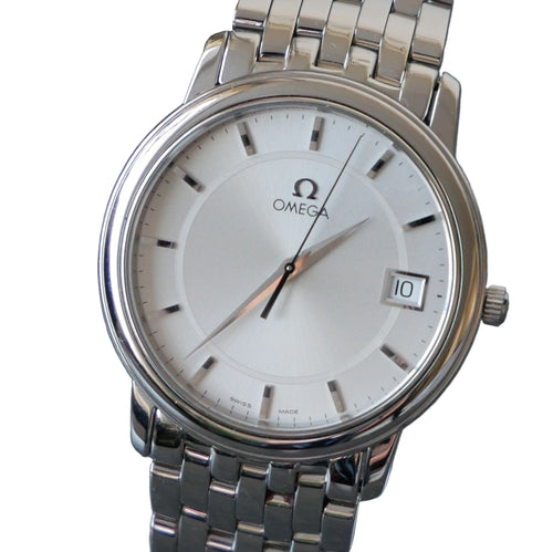 Silver Omega watch with a white dial on a gray background