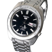 Load image into Gallery viewer, Seiko watch with black dial and silver metal strap on a dark background
