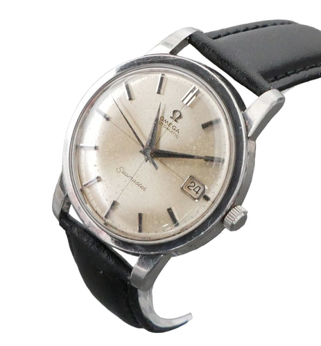 Vintage Omega watch with black leather strap on a gray background
