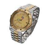 Two-tone watch with gold and silver band on a gray background