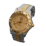 Two-tone silver and gold watch on a gray background