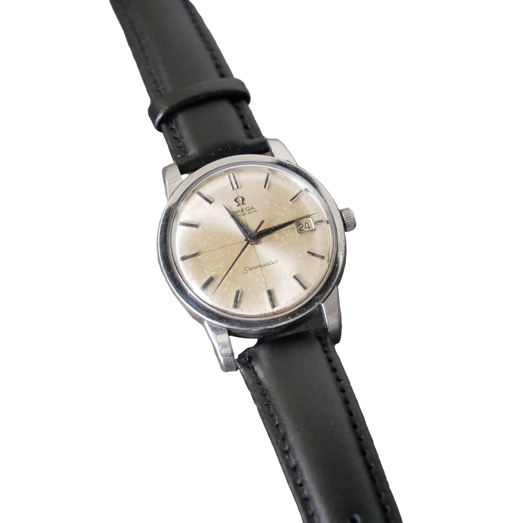 Vintage watch with black leather strap on a gray background