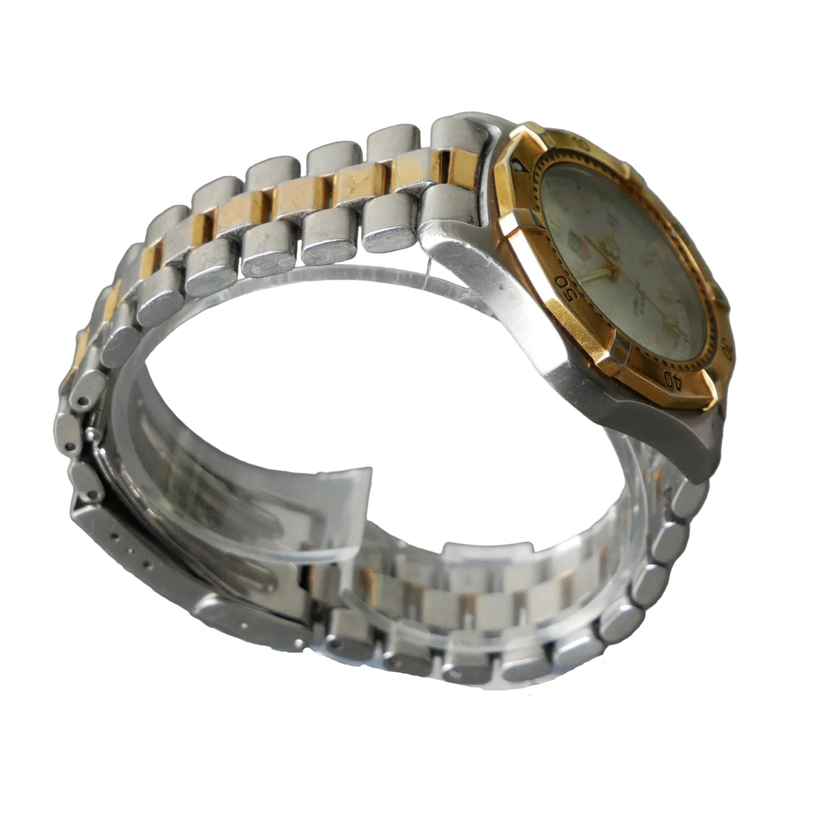 Two-tone silver and gold watch on a gray background